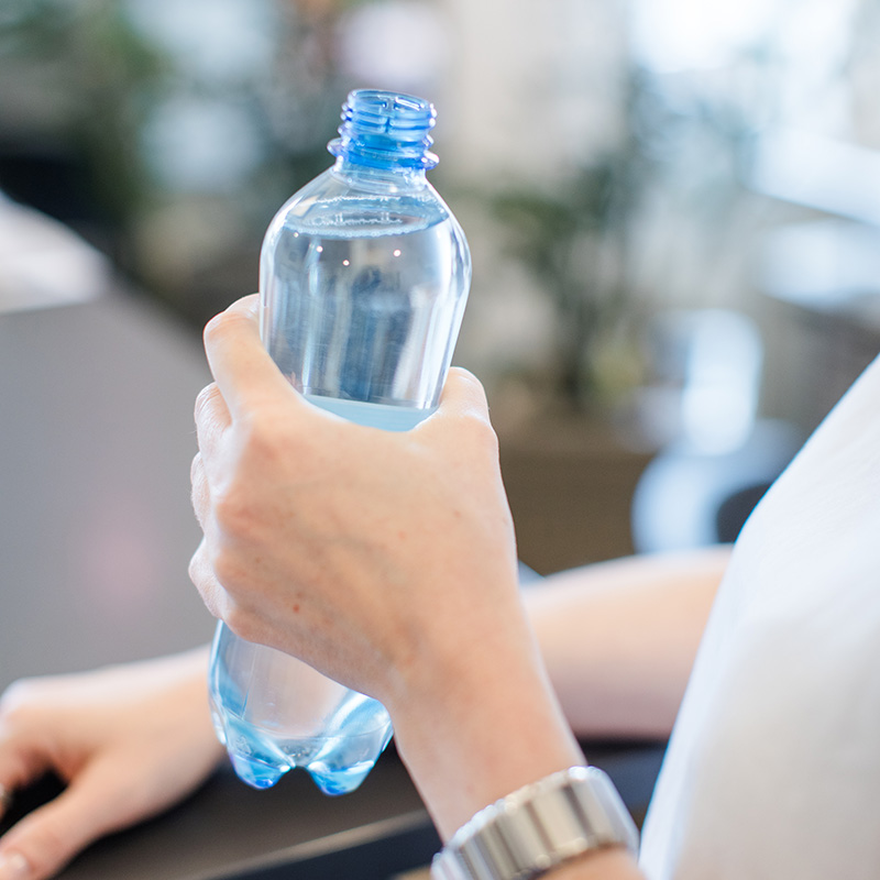 Person hält Wasserflasche in der Hand
